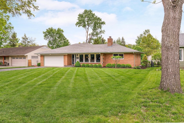 316 Charleston Ave, Columbus, OH 43214 - ranch-style house featuring an attached garage, a chimney, brick siding, a front lawn, and asphalt driveway
