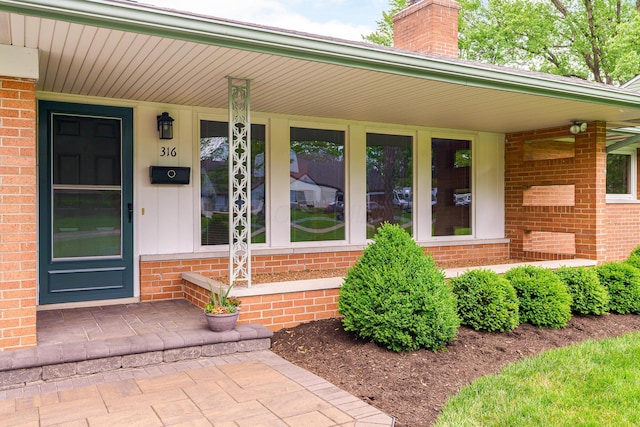 316 Charleston Ave, Columbus, OH 43214 - property entrance featuring brick siding, a porch, and a chimney