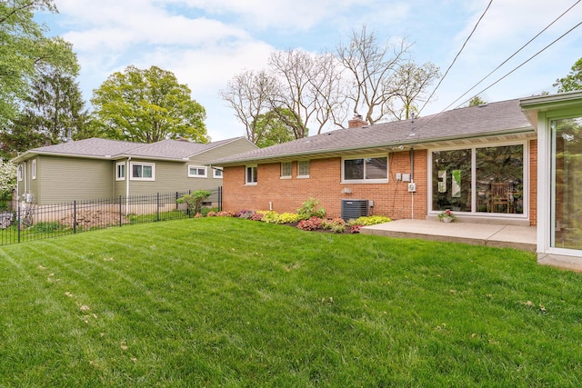 316 Charleston Ave, Columbus, OH 43214 - back of property with a chimney, central AC unit, brick siding, and a patio