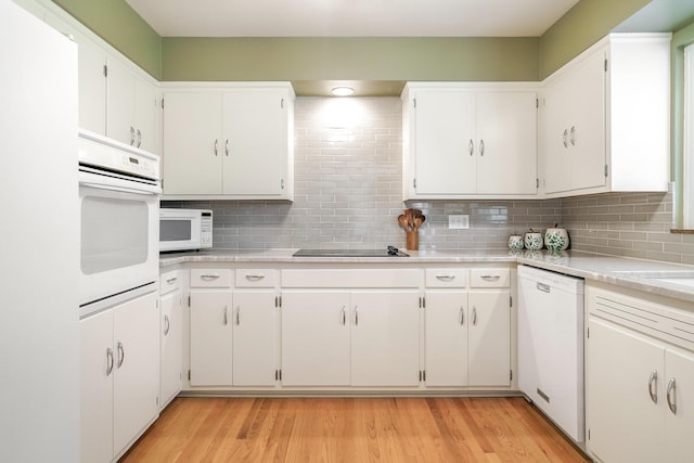 316 Charleston Ave, Columbus, OH 43214 - kitchen featuring white appliances, backsplash, light countertops, and light wood finished floors