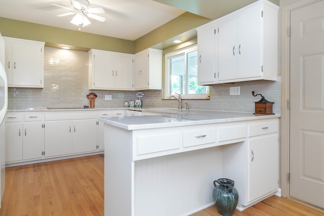 316 Charleston Ave, Columbus, OH 43214 - kitchen with light countertops, decorative backsplash, light wood-style flooring, and white cabinetry