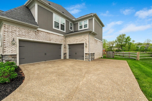 6540 Marshview Dr, Hilliard, OH 43026 - view of property exterior featuring stucco siding, a garage, concrete driveway, and roof with shingles