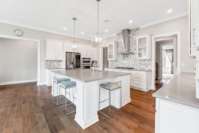 6540 Marshview Dr, Hilliard, OH 43026 - kitchen with stainless steel fridge, wall chimney exhaust hood, gas cooktop, tasteful backsplash, and ornamental molding