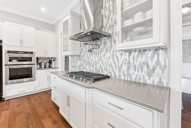6540 Marshview Dr, Hilliard, OH 43026 - kitchen featuring island range hood, appliances with stainless steel finishes, white cabinets, crown molding, and glass insert cabinets