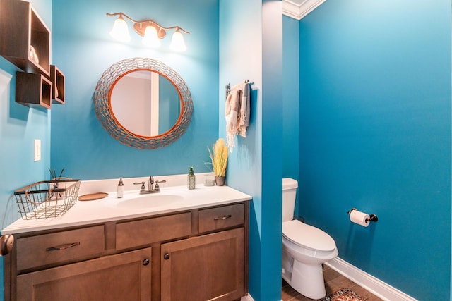 6540 Marshview Dr, Hilliard, OH 43026 - half bathroom featuring toilet, vanity, wood finished floors, and baseboards