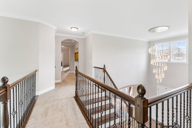 6540 Marshview Dr, Hilliard, OH 43026 - corridor with an upstairs landing, crown molding, arched walkways, baseboards, and carpet floors