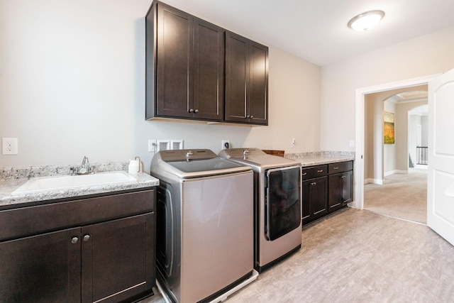 6540 Marshview Dr, Hilliard, OH 43026 - washroom featuring cabinet space, separate washer and dryer, and arched walkways
