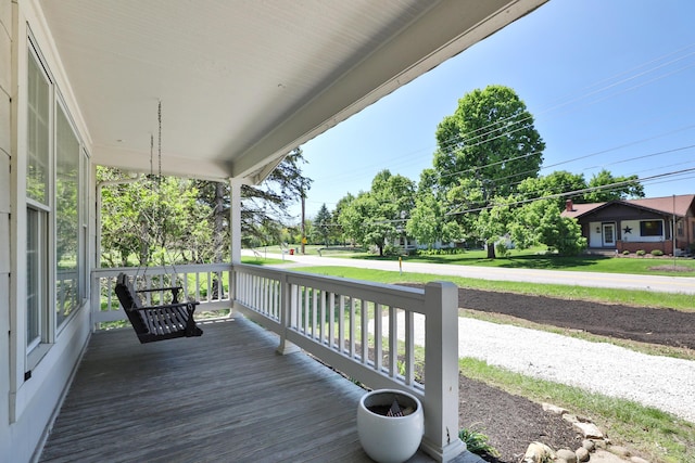 wooden terrace featuring covered porch
