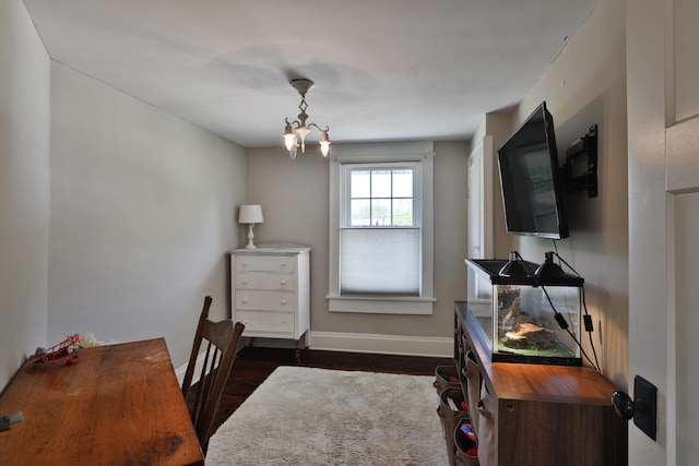 home office with dark wood finished floors, baseboards, and a chandelier