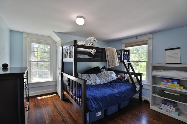 bedroom featuring wood finished floors and baseboards