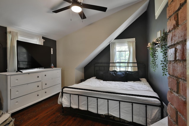 bedroom with dark wood-type flooring, vaulted ceiling, and ceiling fan
