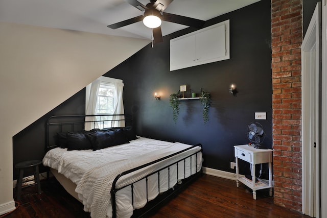 bedroom with wood finished floors, baseboards, vaulted ceiling, and ceiling fan