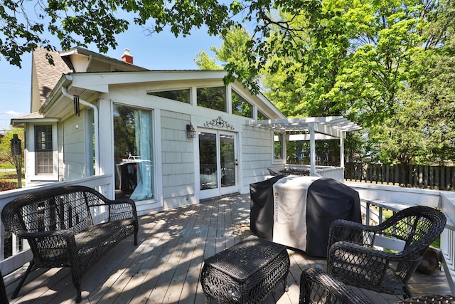 wooden terrace featuring a pergola and a grill