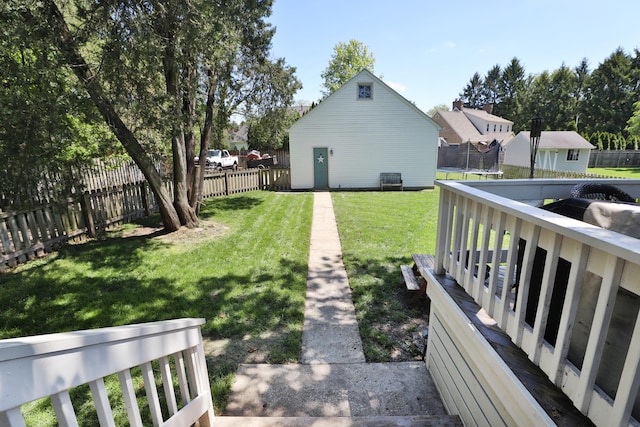 view of yard featuring a trampoline and an outdoor structure