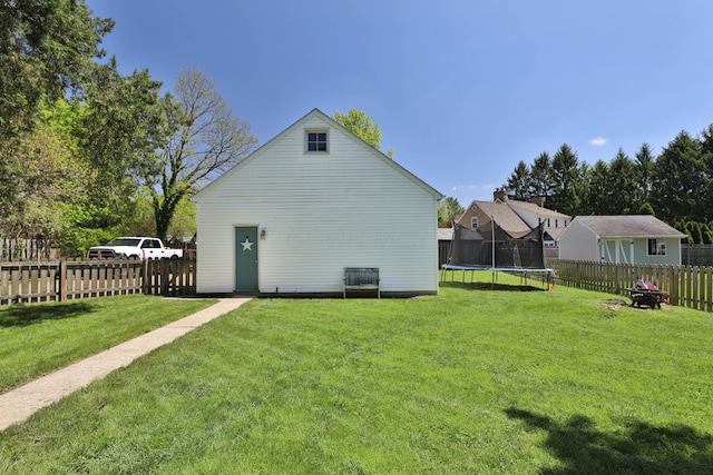 rear view of property with a trampoline