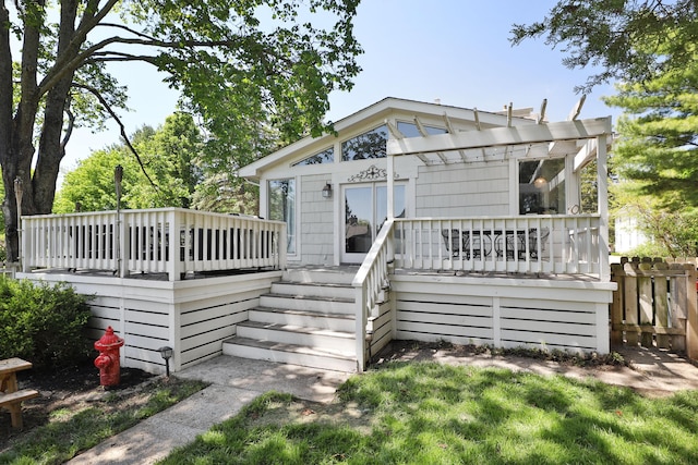 rear view of house featuring a deck, fence, and stairs