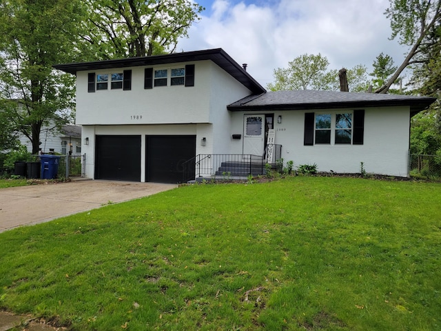 1989 Torchwood Dr, Columbus, OH 43229 - split level home featuring an attached garage, driveway, and stucco siding