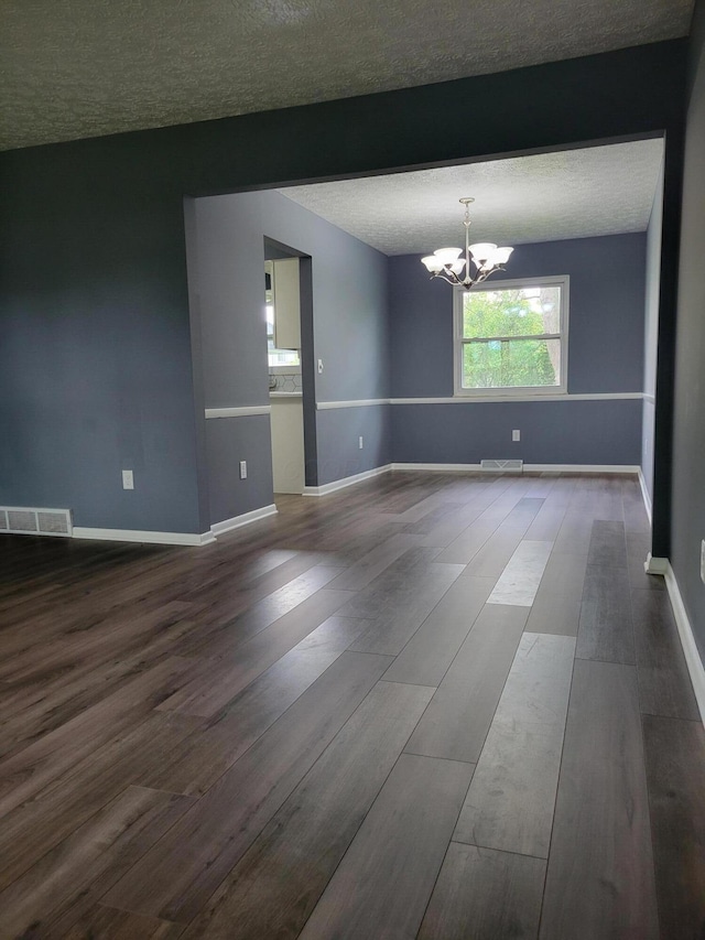 1989 Torchwood Dr, Columbus, OH 43229 - spare room with a chandelier, wood finished floors, a textured ceiling, and baseboards