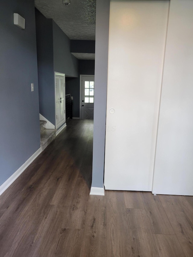 1989 Torchwood Dr, Columbus, OH 43229 - hallway with wood finished floors, baseboards, and a textured ceiling
