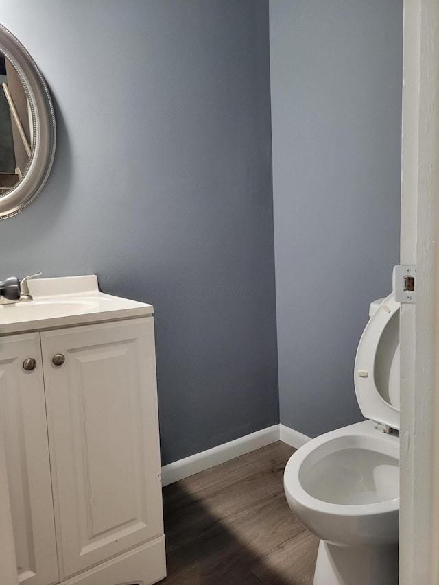 1989 Torchwood Dr, Columbus, OH 43229 - bathroom featuring toilet, wood finished floors, baseboards, and vanity