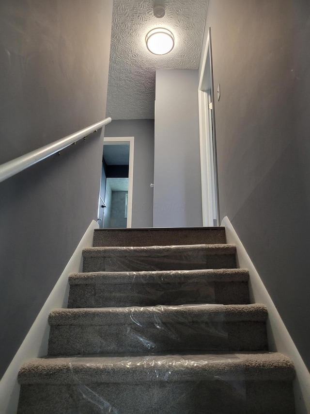 1989 Torchwood Dr, Columbus, OH 43229 - staircase featuring a textured ceiling