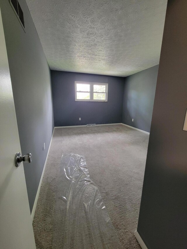 1989 Torchwood Dr, Columbus, OH 43229 - empty room with carpet floors, baseboards, and a textured ceiling