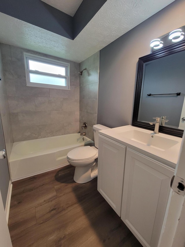 1989 Torchwood Dr, Columbus, OH 43229 - bathroom featuring toilet, a textured ceiling, shower / bath combination, wood finished floors, and vanity