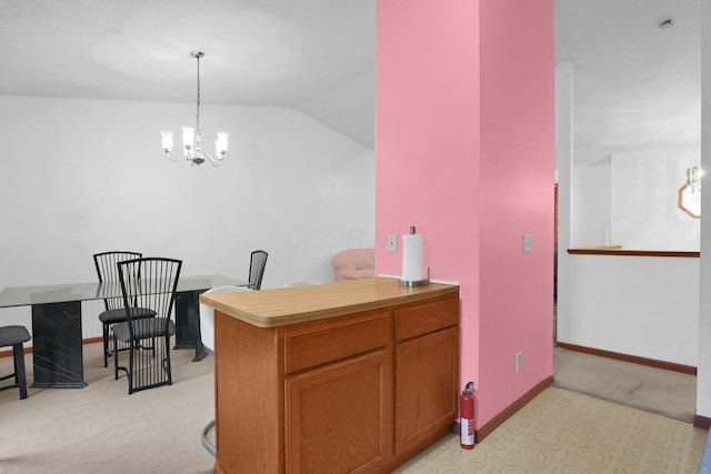 kitchen with light colored carpet, a chandelier, light countertops, baseboards, and lofted ceiling