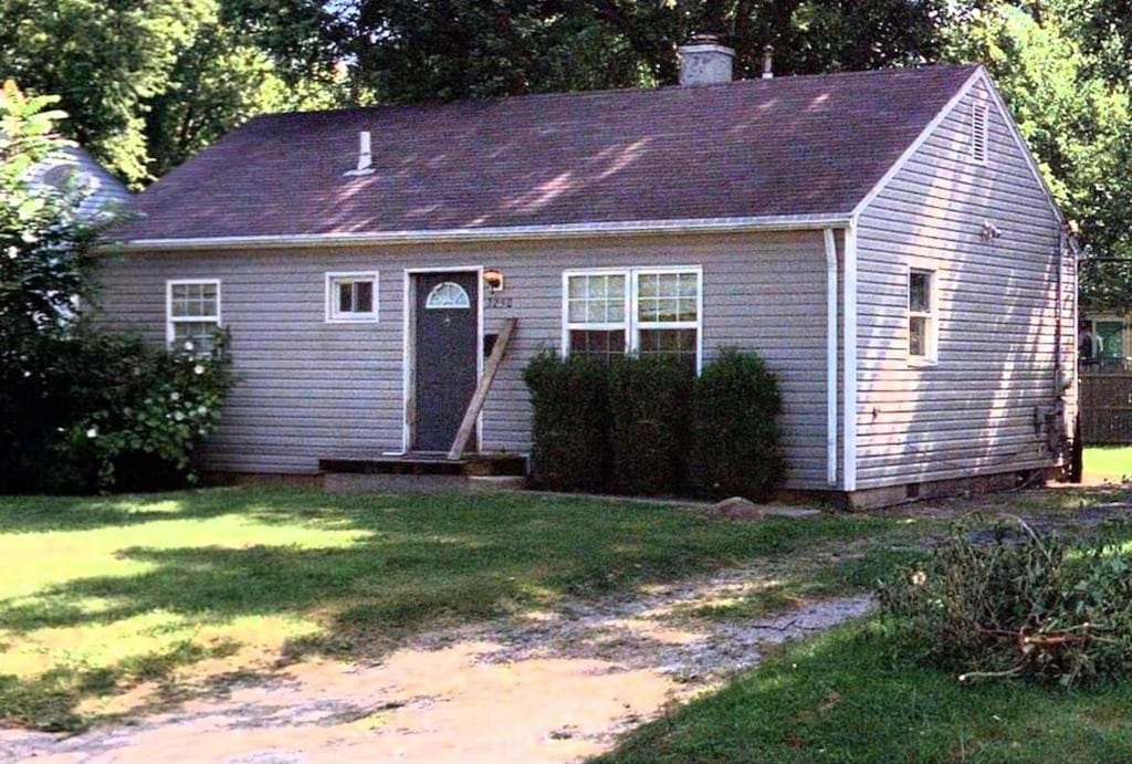 3250 Karl Rd, Columbus, OH 43224 - view of front of property with a front lawn and a chimney
