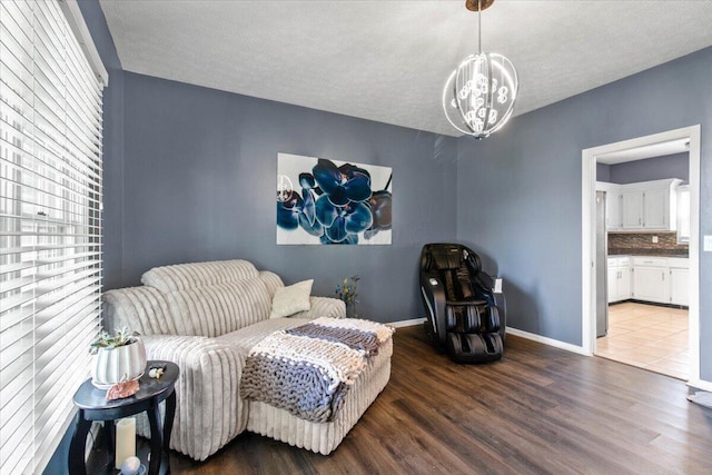 10164 Busey Rd, Canal Winchester, OH 43110 - sitting room featuring wood finished floors, a chandelier, and a textured ceiling