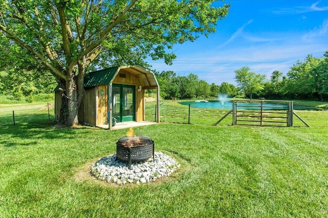 10164 Busey Rd, Canal Winchester, OH 43110 - view of yard featuring a water view, an outdoor fire pit, and an outdoor structure