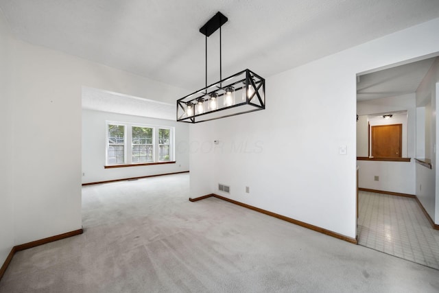 unfurnished dining area with baseboards, carpet flooring, and a chandelier