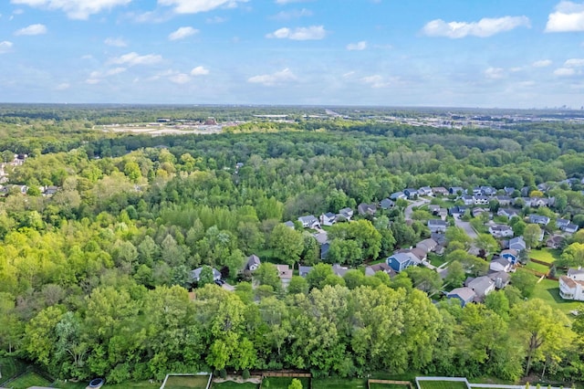 aerial view of property's location featuring a heavily wooded area