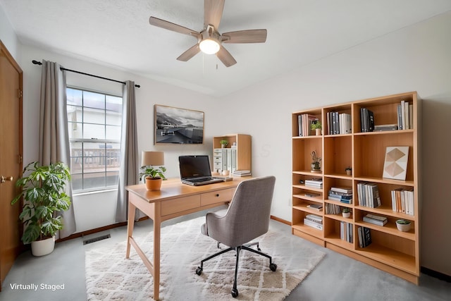 office area featuring a ceiling fan and baseboards