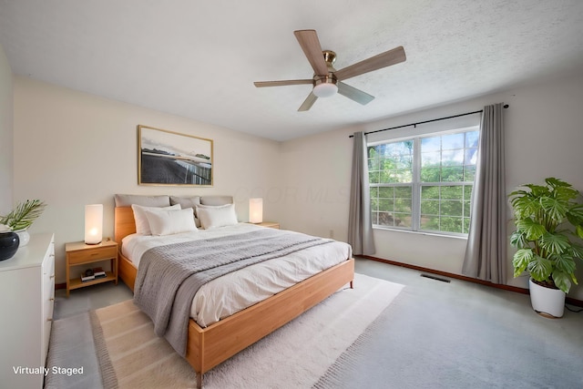 bedroom with baseboards, a ceiling fan, and light carpet