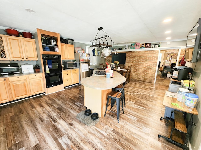 8696 Main St, Rushville, OH 43150 - kitchen featuring appliances with stainless steel finishes, light brown cabinets, wood finished floors, and a kitchen bar