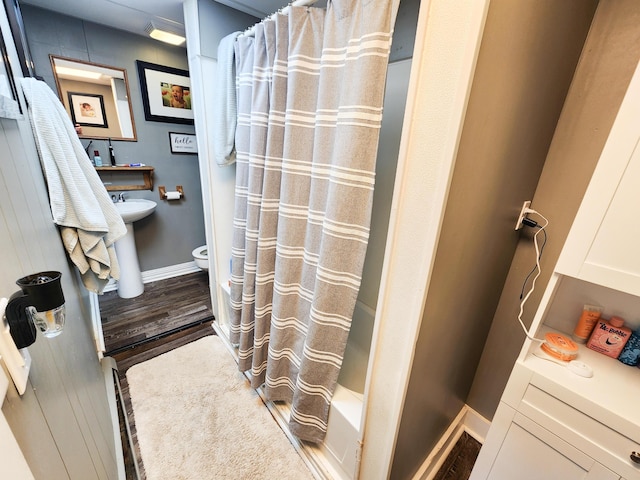8696 Main St, Rushville, OH 43150 - full bath with toilet, baseboards, wood finished floors, and shower / bathtub combination with curtain