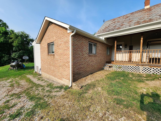 8696 Main St, Rushville, OH 43150 - view of property exterior with a lawn, brick siding, and a chimney