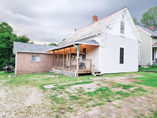 8696 Main St, Rushville, OH 43150 - rear view of property with a chimney, a deck, and brick siding