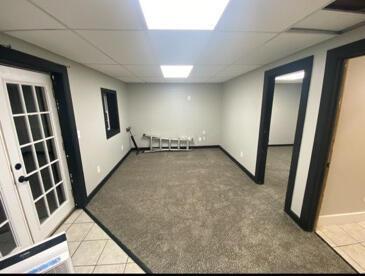 8696 Main St, Rushville, OH 43150 - finished below grade area featuring a paneled ceiling, light tile patterned flooring, light colored carpet, and baseboards