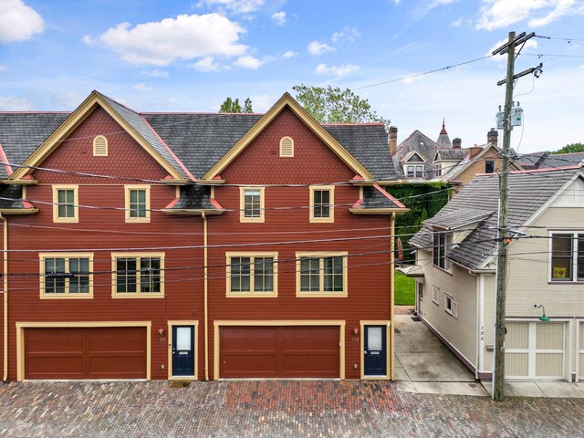103 Lundy St, Columbus, OH 43215 - view of front facade featuring driveway and a garage