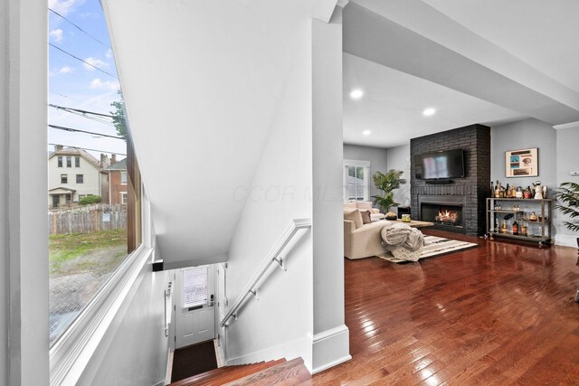103 Lundy St, Columbus, OH 43215 - stairway featuring a fireplace, hardwood / wood-style flooring, and recessed lighting