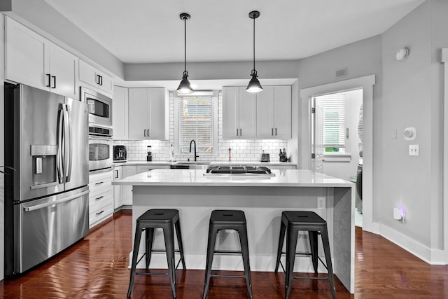 103 Lundy St, Columbus, OH 43215 - kitchen featuring stainless steel appliances, plenty of natural light, a sink, and tasteful backsplash