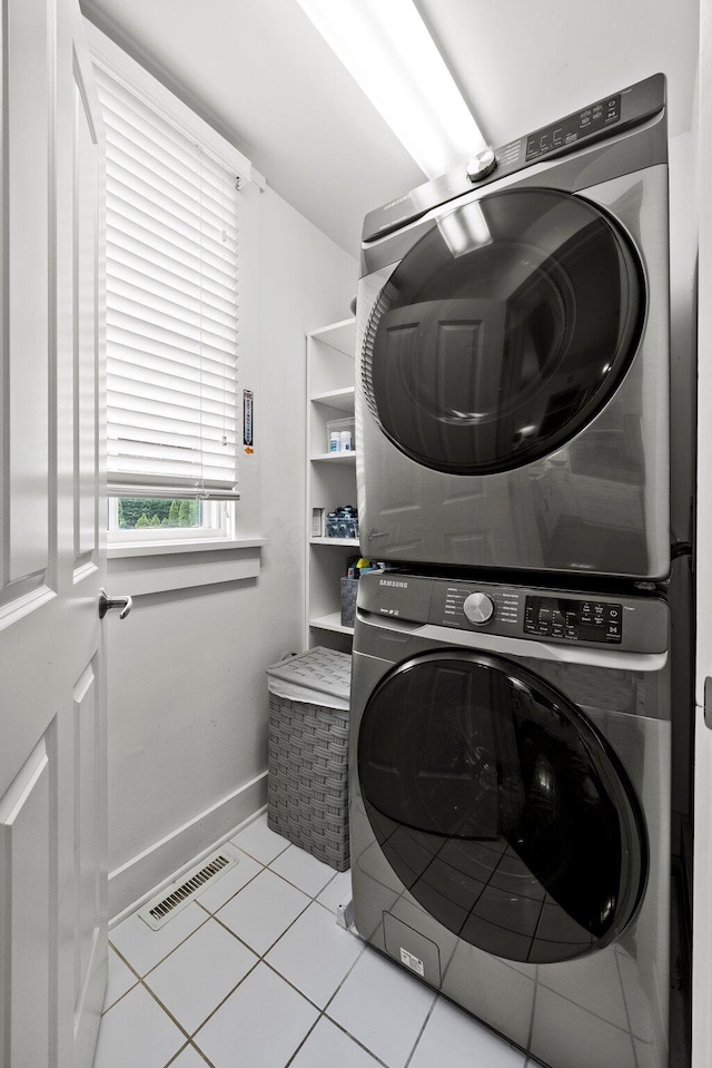 103 Lundy St, Columbus, OH 43215 - washroom with stacked washer / dryer, baseboards, and light tile patterned flooring