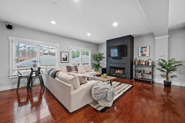 103 Lundy St, Columbus, OH 43215 - living area featuring a brick fireplace, wood finished floors, recessed lighting, and baseboards