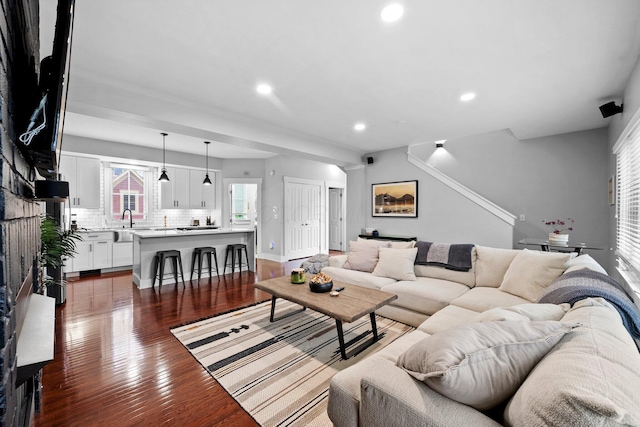 103 Lundy St, Columbus, OH 43215 - living room with recessed lighting, dark wood-type flooring, stairs, and baseboards