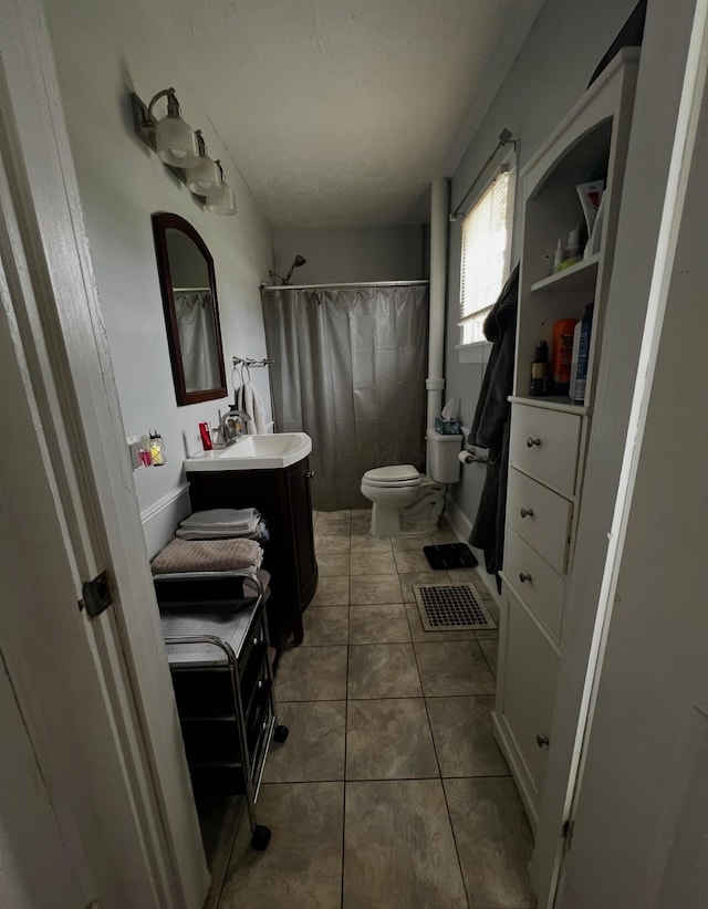44 King Ave, Newark, OH 43055 - full bath with vanity, toilet, a textured ceiling, tile patterned flooring, and a shower with curtain