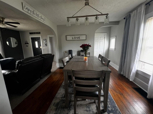 44 King Ave, Newark, OH 43055 - dining area featuring arched walkways, dark wood-type flooring, ceiling fan, baseboards, and a textured ceiling