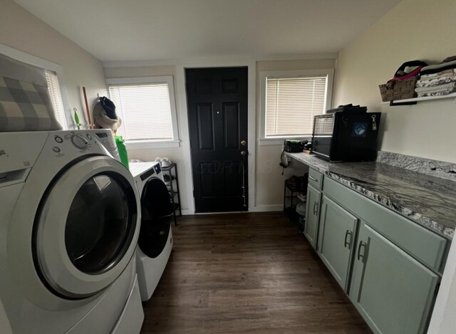44 King Ave, Newark, OH 43055 - clothes washing area featuring washing machine and dryer, healthy amount of natural light, dark wood finished floors, and cabinet space