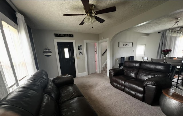 44 King Ave, Newark, OH 43055 - living room featuring arched walkways, a textured ceiling, carpet flooring, ceiling fan, and stairs